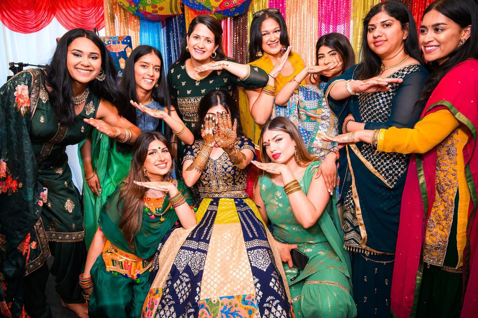 Women and children celebrating together in colourful traditional outfits
