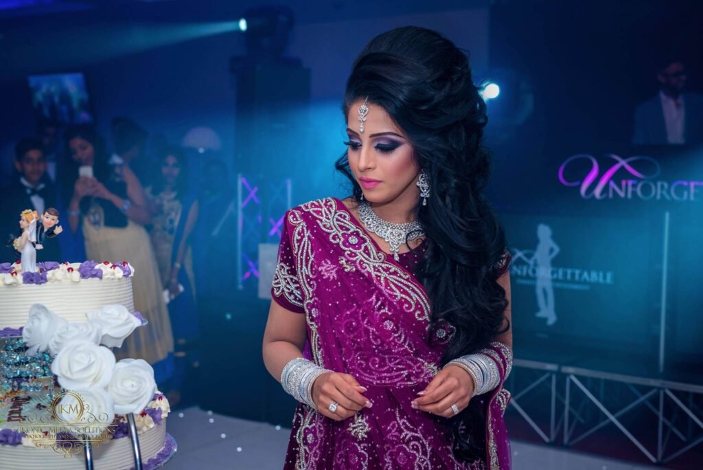 Bride photographed under dramatic reception lighting at a Birmingham Asian wedding