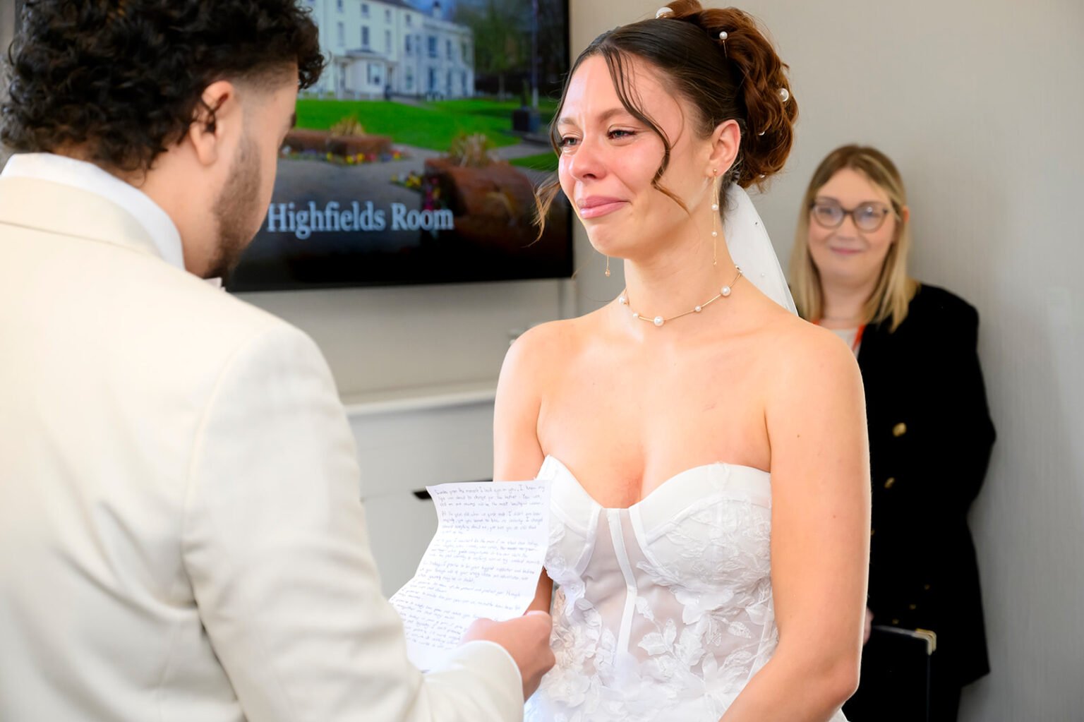 Bride and groom holding hands during their civil ceremony at Sandwell Register Office