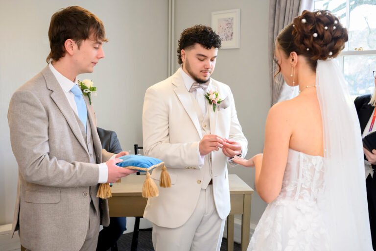 Groom placing a wedding ring on the bride’s finger during a civil ceremony