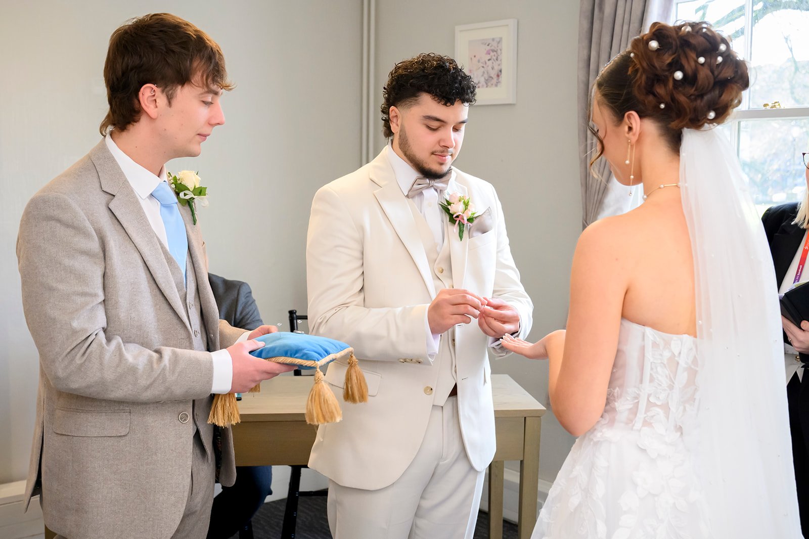 Groom placing a wedding ring on the bride during a Sandwell civil ceremony near Wednesbury