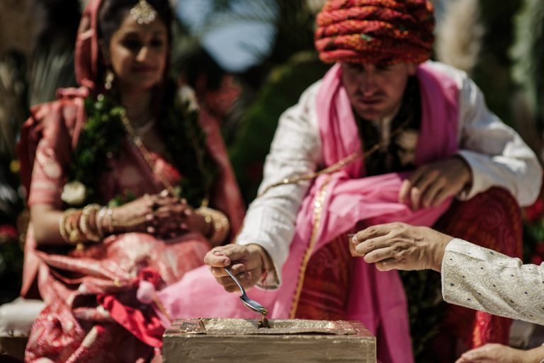 Hands taking part in a Hindu wedding ceremony ritual