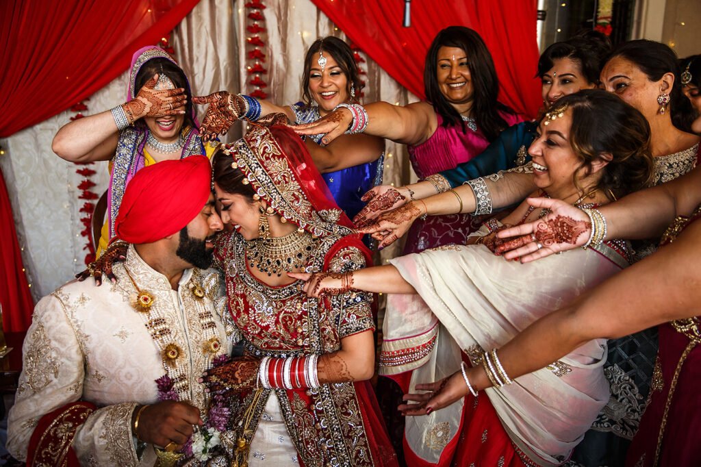Family and friends celebrating with the couple at an Asian wedding in Birmingham