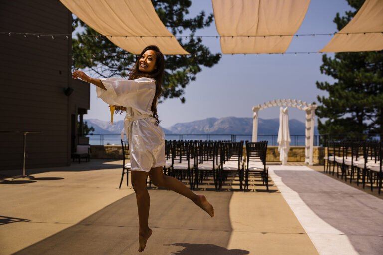 Bride dancing beside an outdoor ceremony setting at the wedding