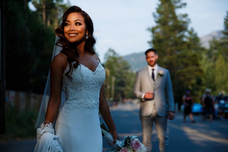 Bride in evening light with the groom softly framed behind her