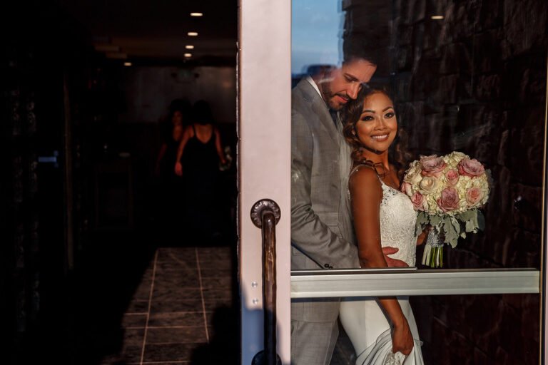 Bride and groom sharing a quiet doorway portrait after their ceremony