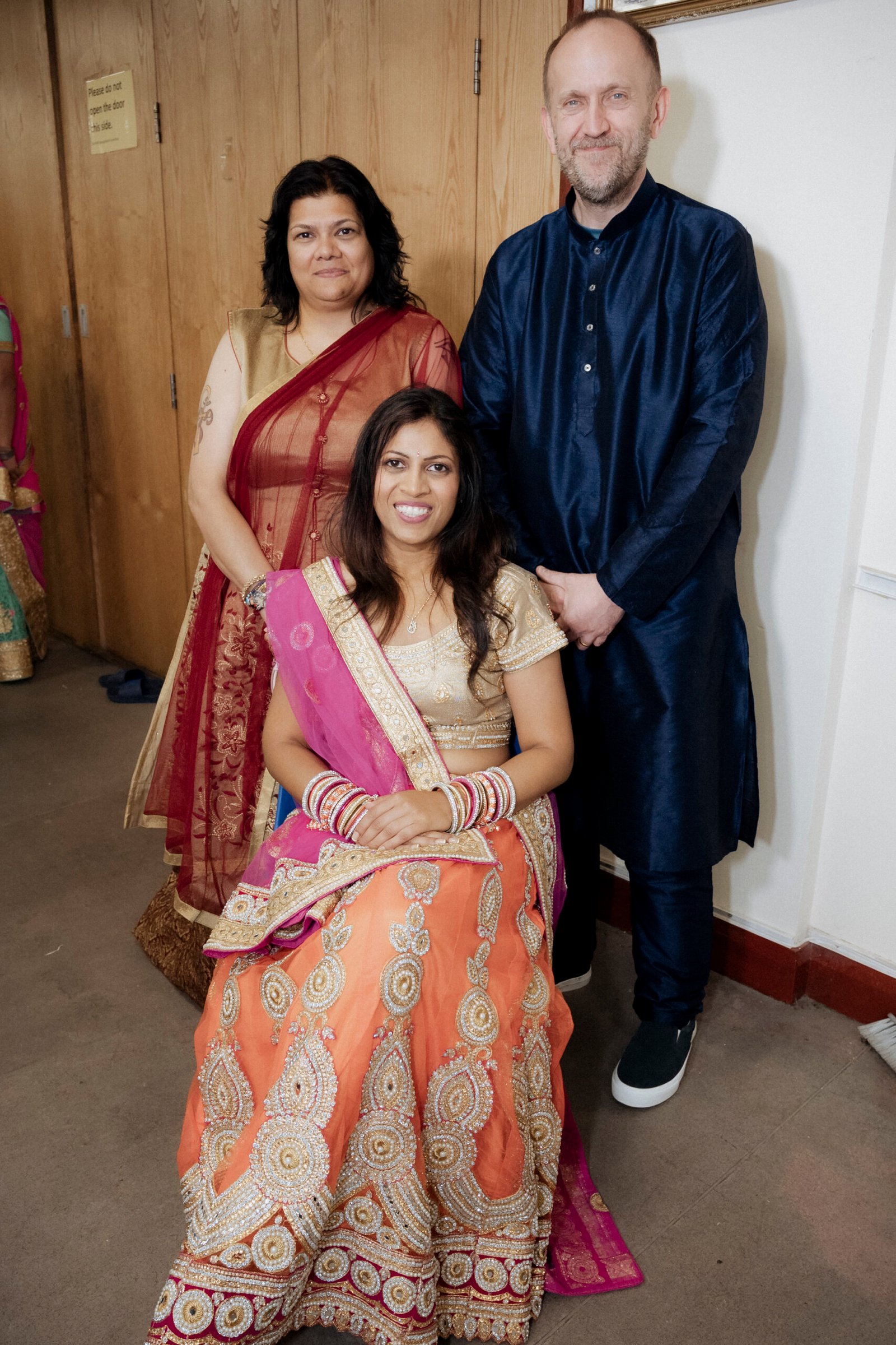 Hindu priest reading from the sacred texts and directing offerings during a Gujarati Mandap Muhurat puja in Birmingham, captured by Ikonic Media Solutions
