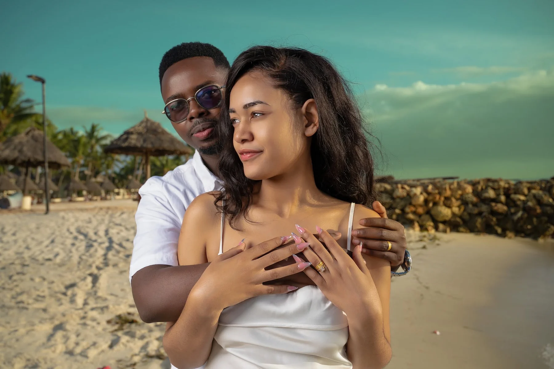 Engaged couple embracing during a beach pre-wedding shoot in Dar es Salaam