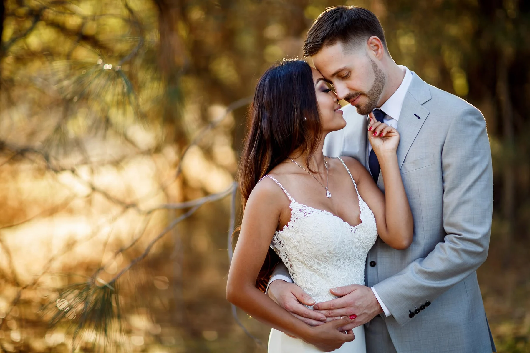 Bride and groom sharing a quiet woodland wedding portrait