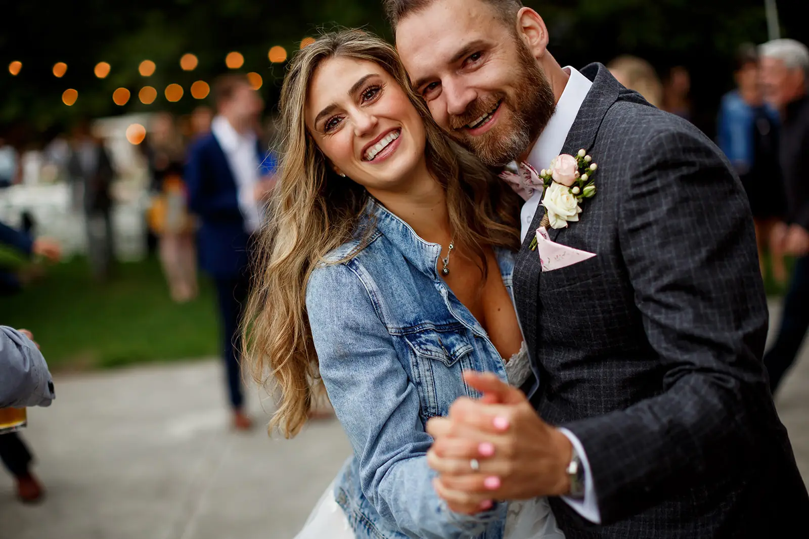 Newlyweds smiling together during an outdoor dance