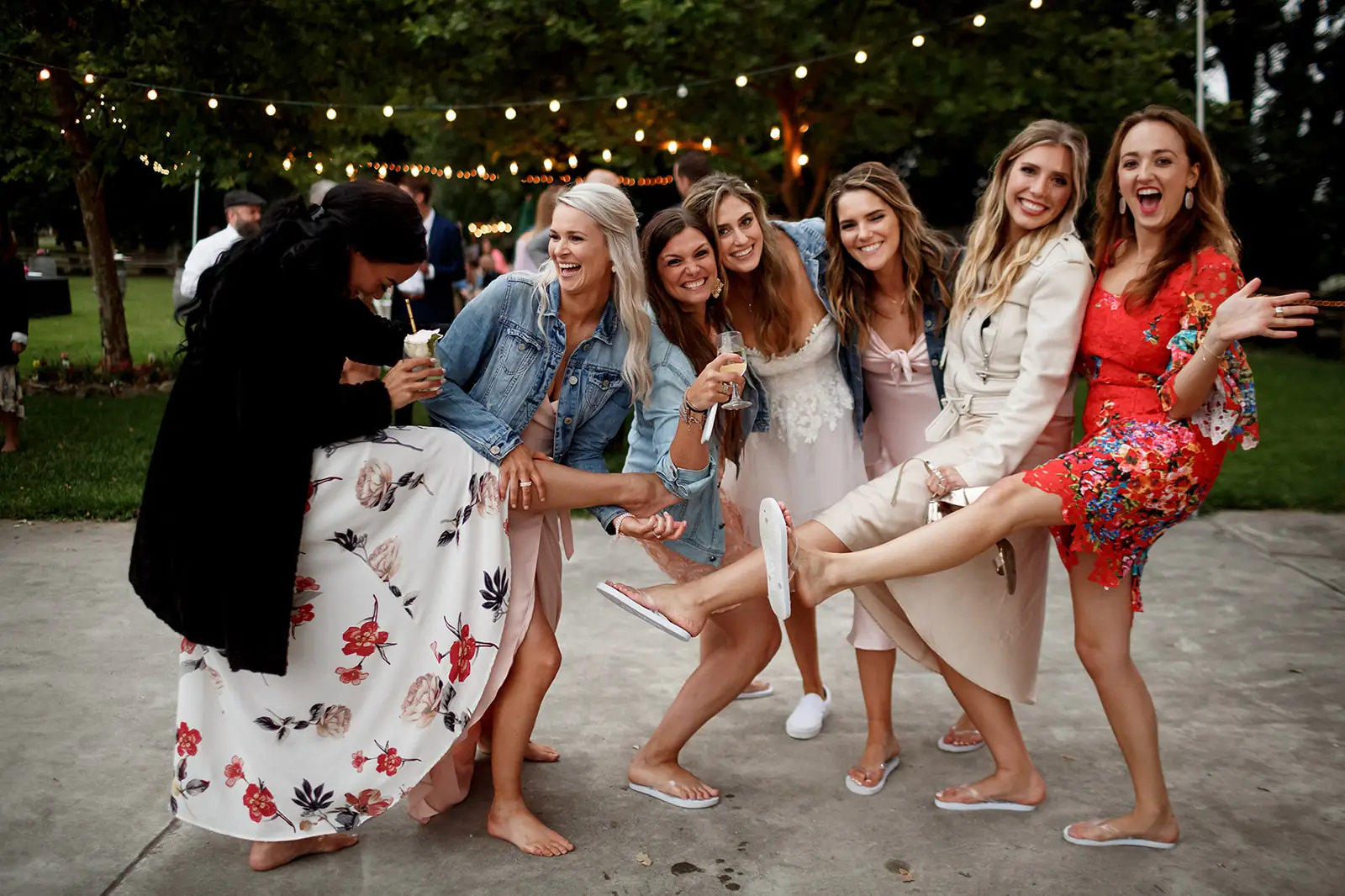 Bride laughing with friends during evening wedding celebrations