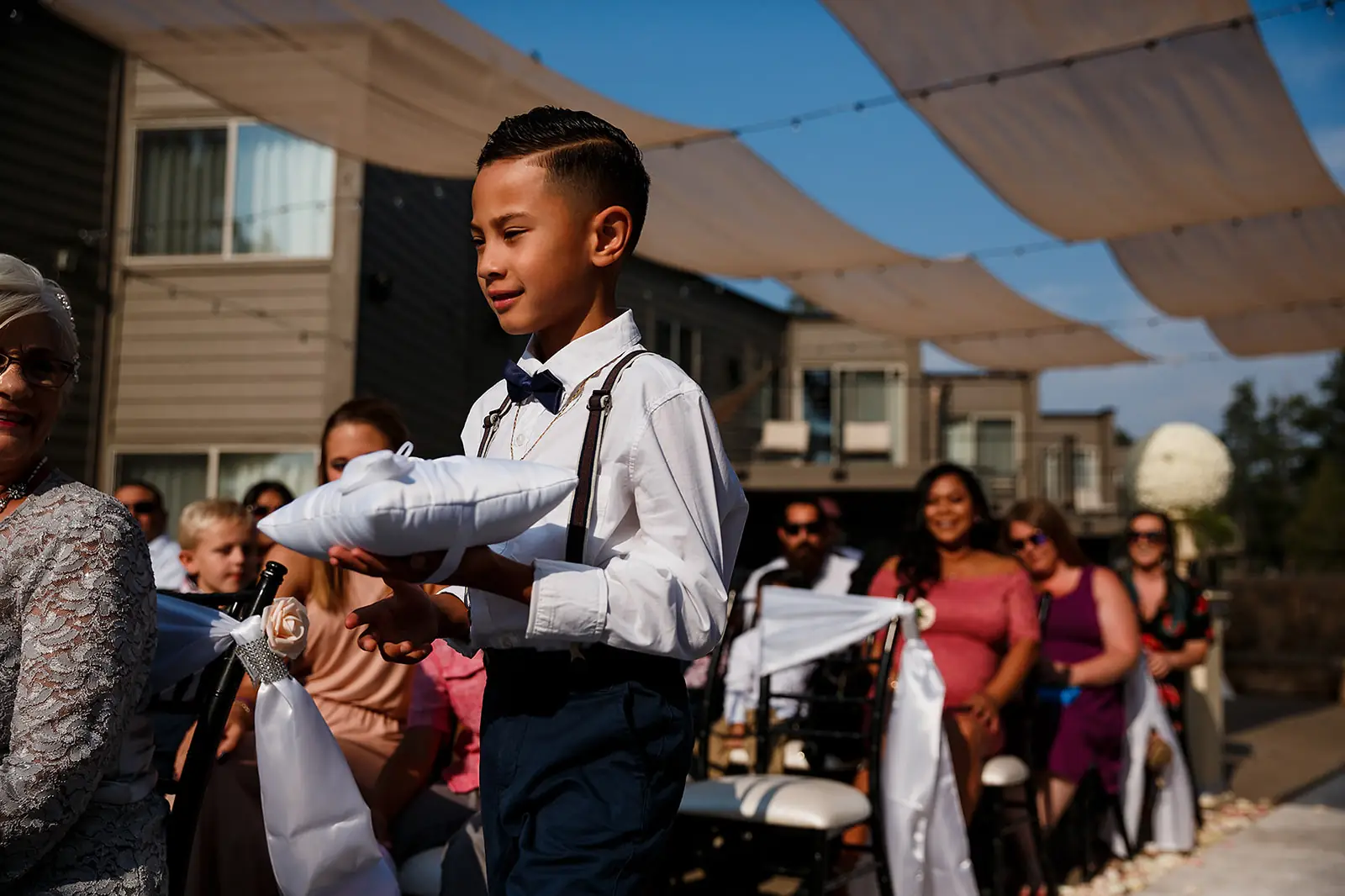 Guest holding a baby during an outdoor wedding celebration