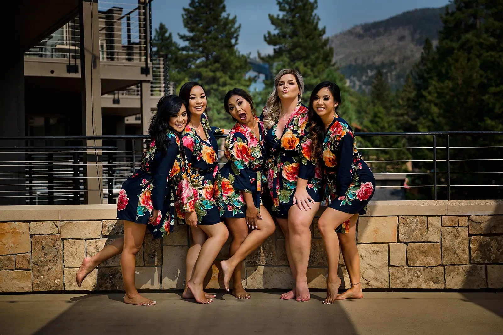 Bridesmaids in matching robes sitting together before the wedding