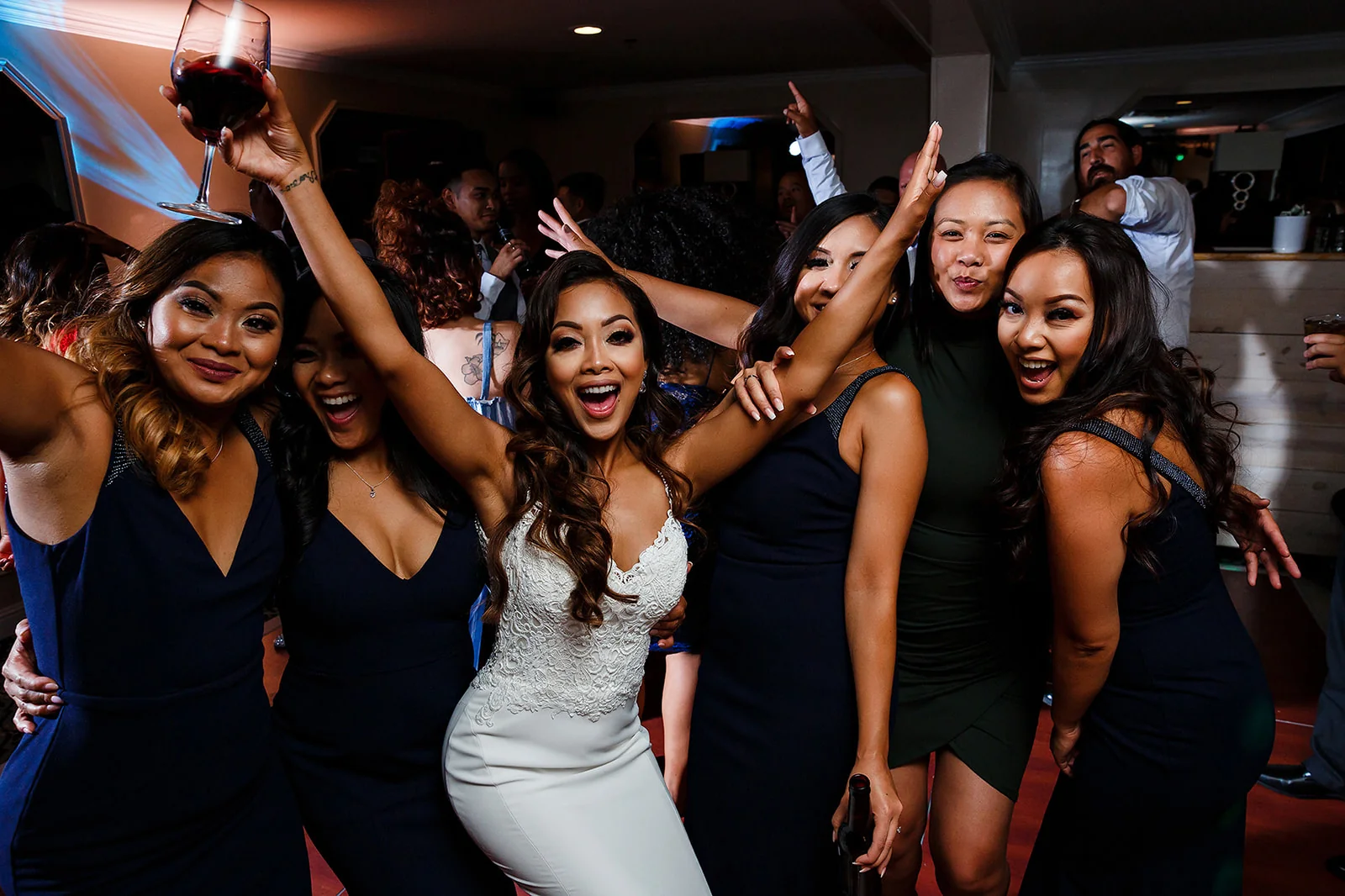 Bride and friends celebrating together on the dance floor