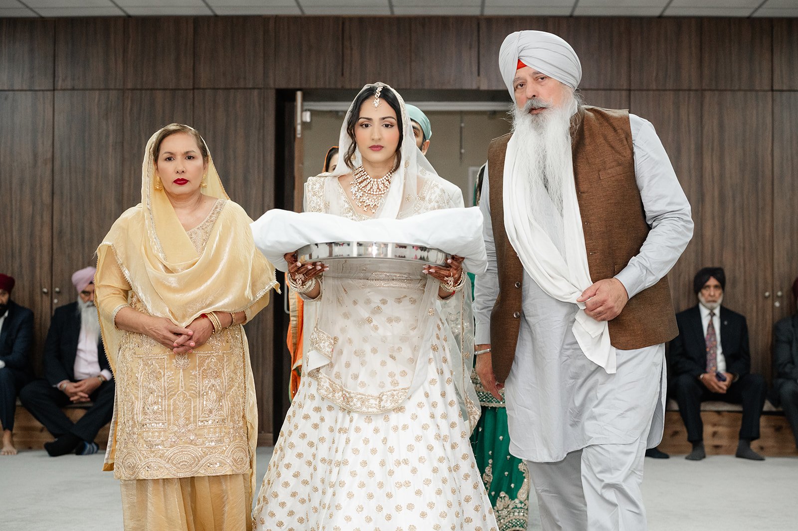 Bride entering the gurdwara with family for her Anand Karaj