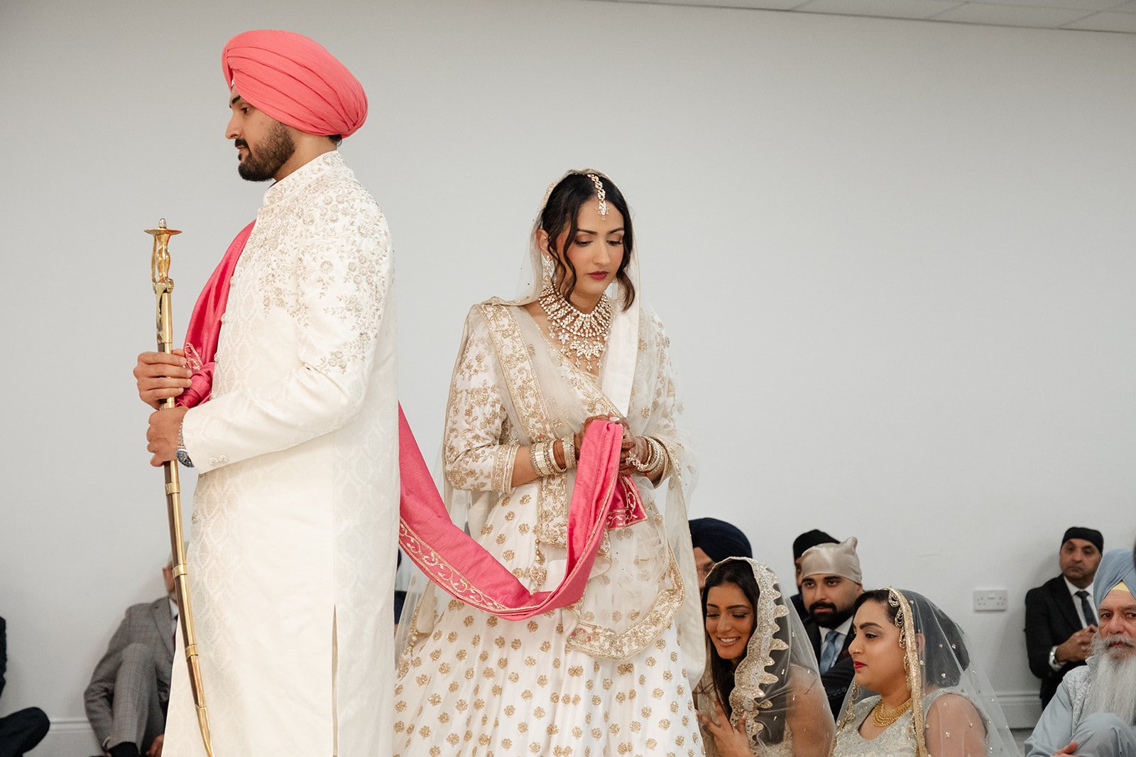 Bride following the groom during the Sikh wedding ceremony